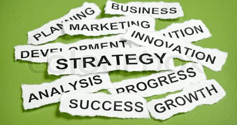 Torn newspaper headlines depicting business strategy